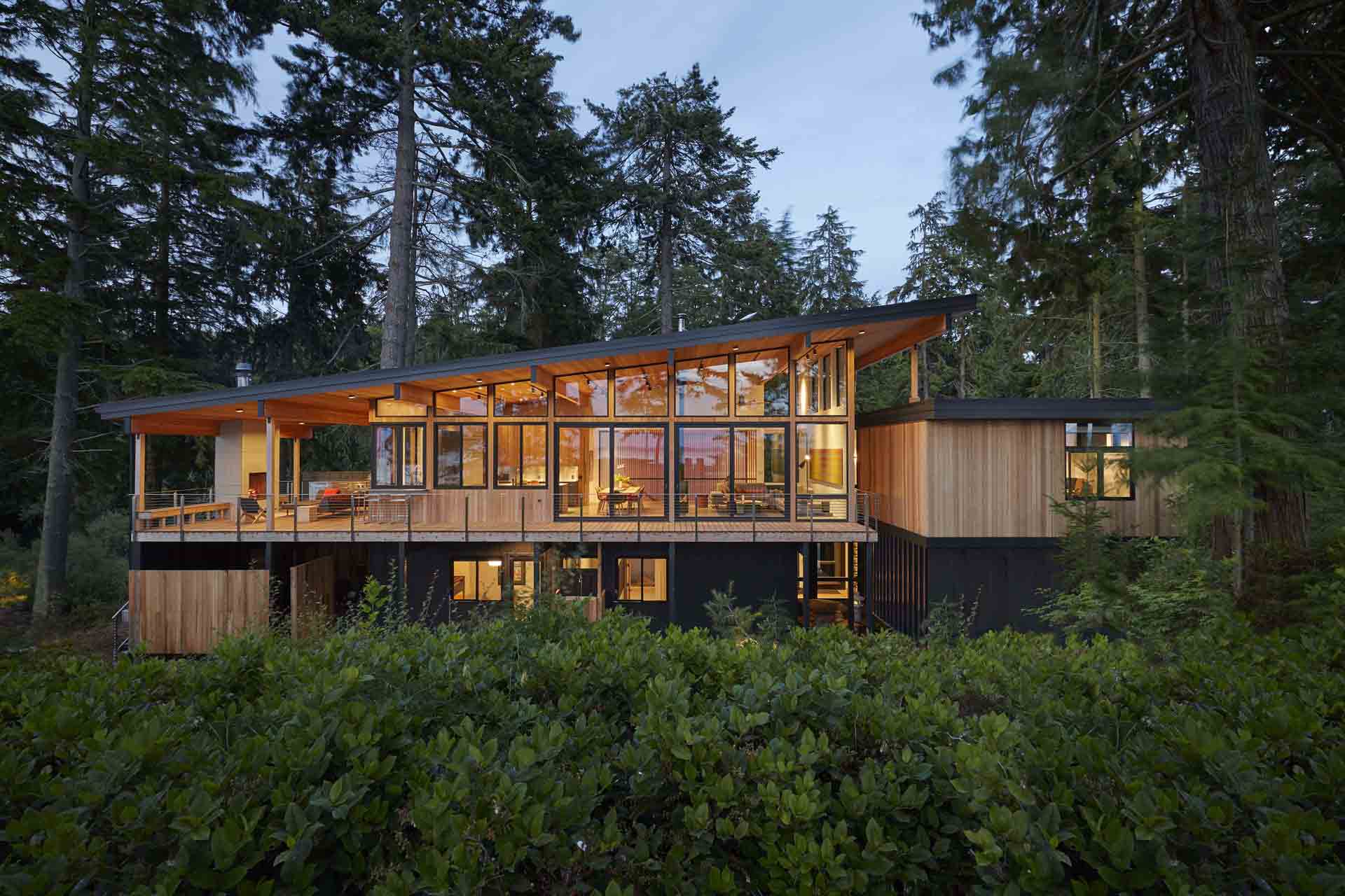 modern post beam lake house floor to ceiling windows